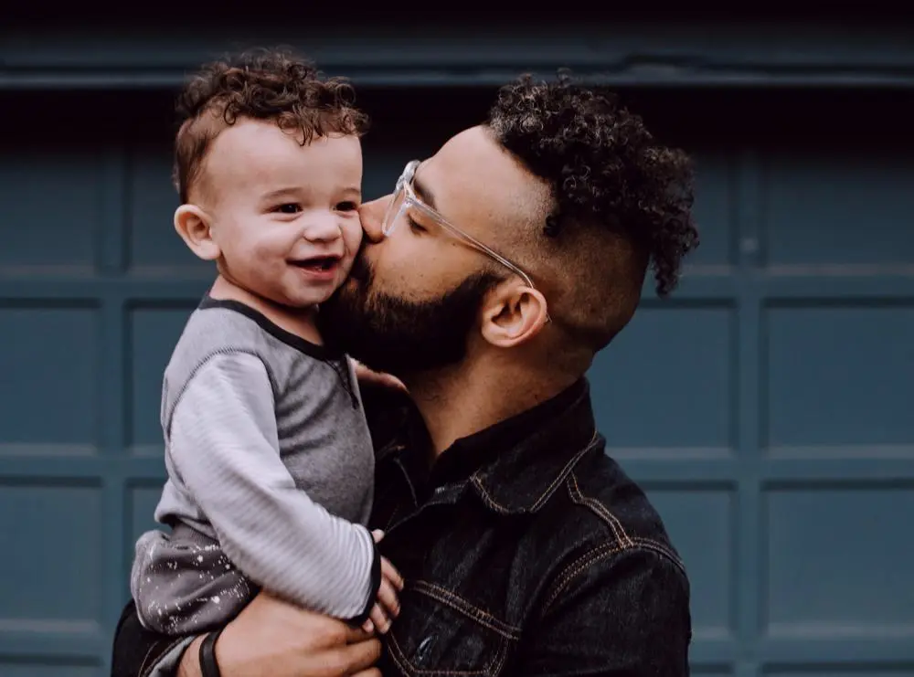 Man kissing child on the cheek